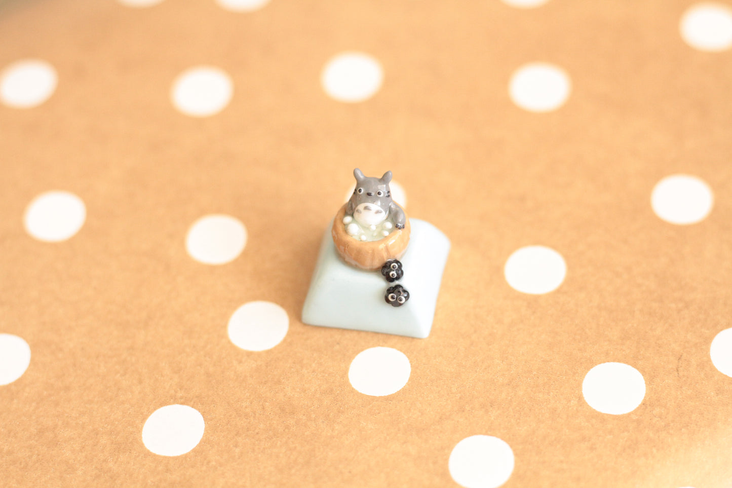 Totoro soaking in an onsen with soot buddies.