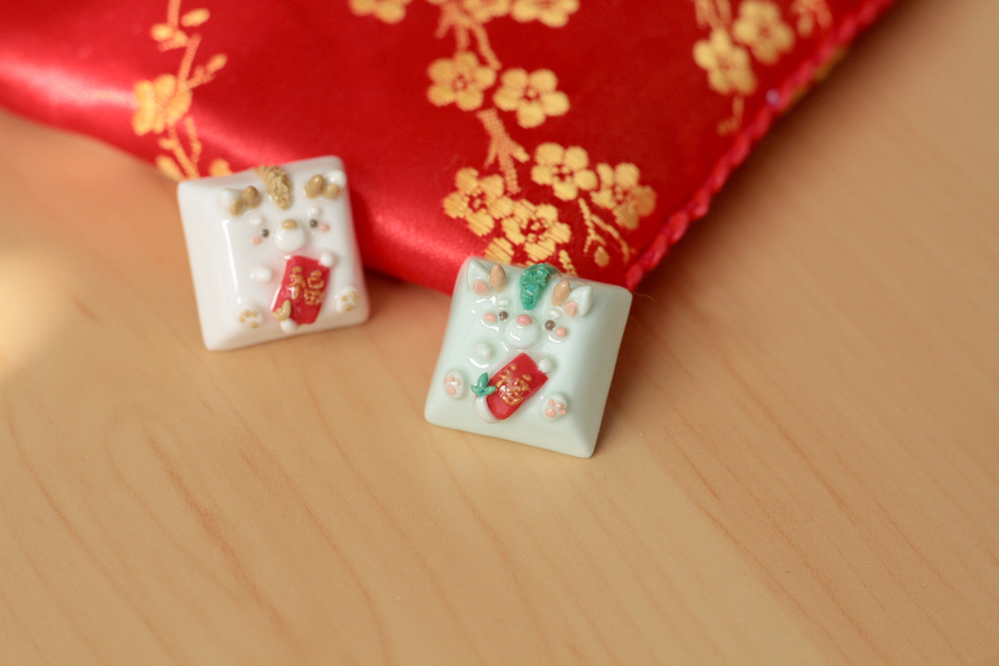 New Year Dragons in light green & white/gold color variations. Both holding a red envelope.