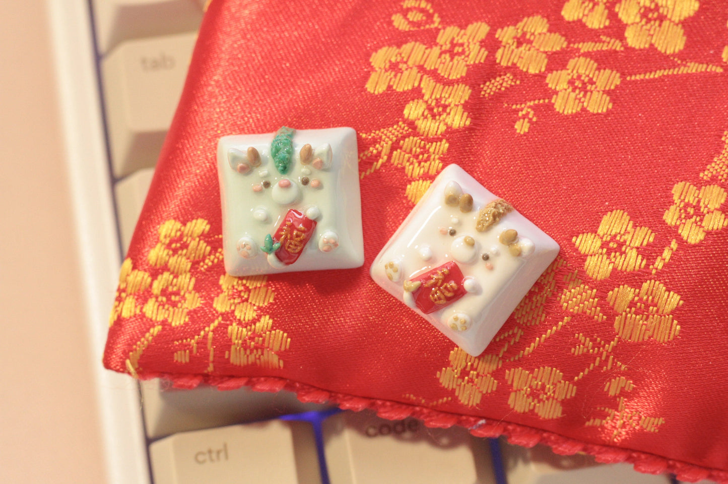 New Year Dragons in light green & white/gold color variations. Both holding a red envelope.