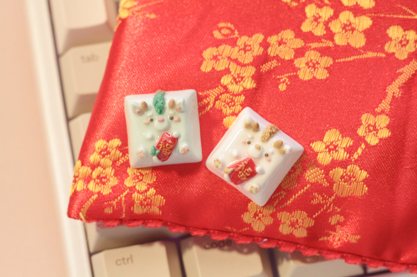 New Year Dragons in light green & white/gold color variations. Both holding a red envelope.