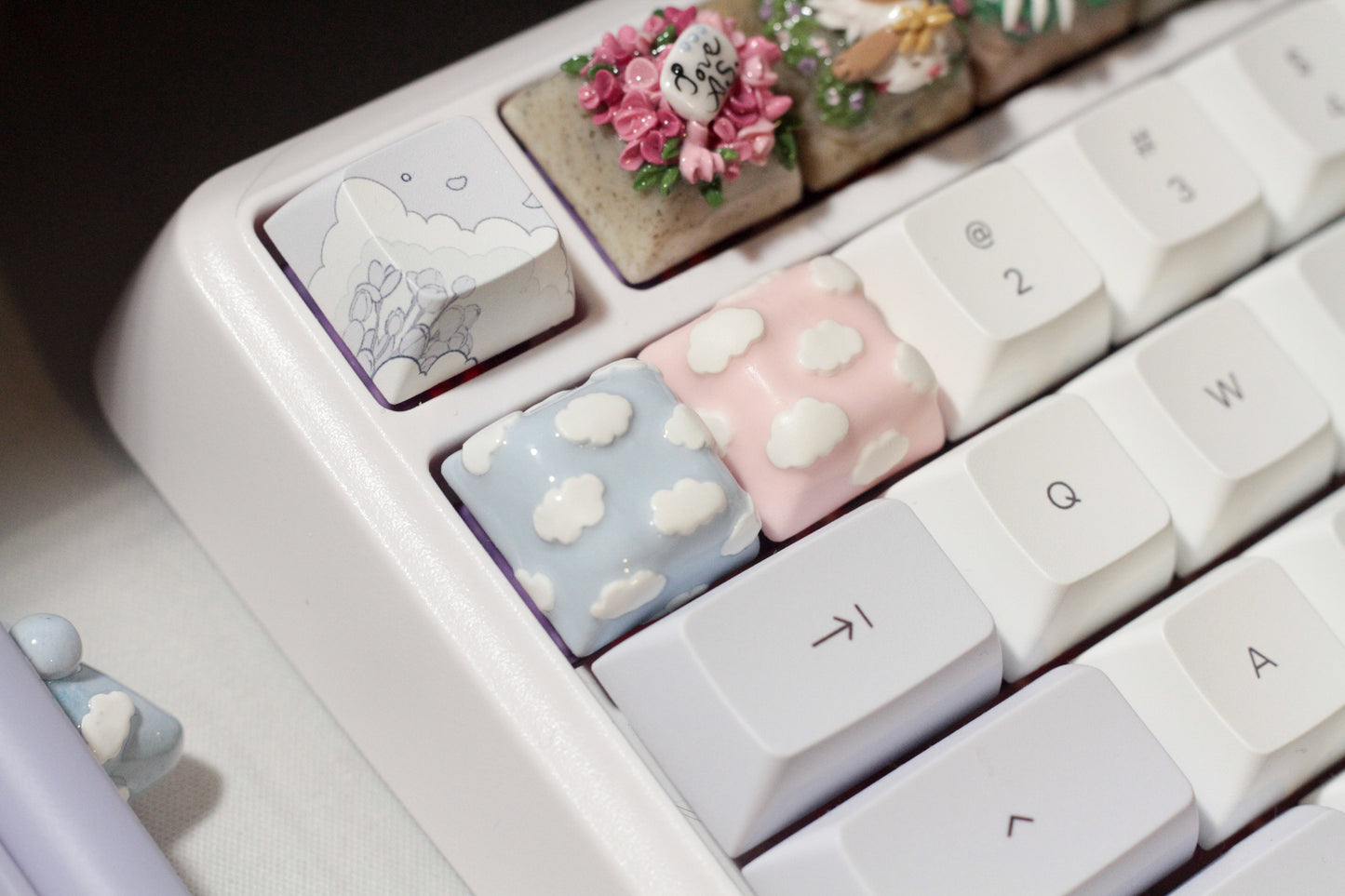 Cute Clouds Polymer Clay keycaps in pastel blue and pastel pink.