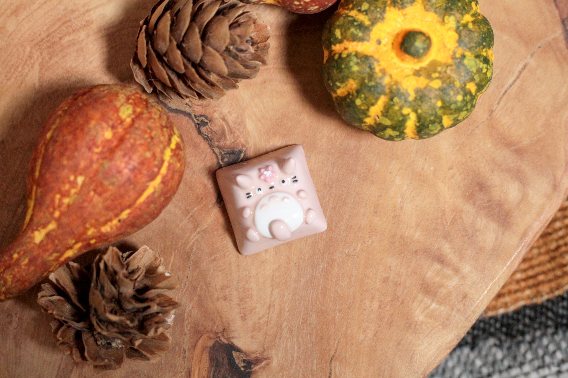 Three Totoro variations: Grey/green Totoro with leaf on the head, Pink Totoro with sakura flower on the head, and grey Totoro with soot spirit on the head.