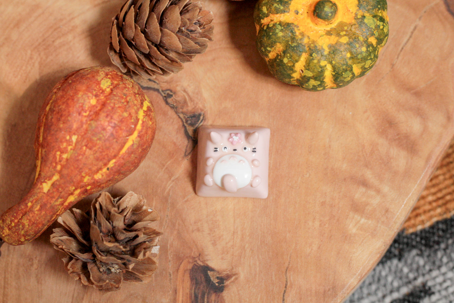 Three Totoro variations: Grey/green Totoro with leaf on the head, Pink Totoro with sakura flower on the head, and grey Totoro with soot spirit on the head.