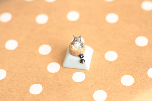 Totoro soaking in an onsen with soot buddies.